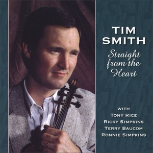 A man holding a violin in front of him.